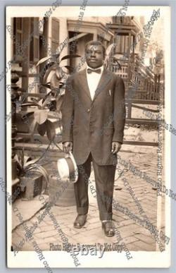 Antique RPPC portrait black man on sidewalk African American Real Photo Postcard