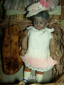 Antique dollhouse-size black bisque S & H sockethead mignonette doll withwardrobe