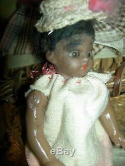 Antique dollhouse-size black bisque S & H sockethead mignonette doll withwardrobe