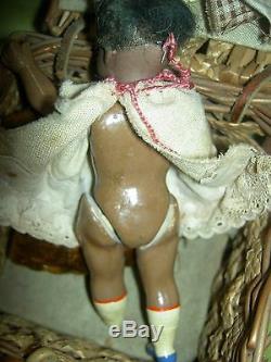 Antique dollhouse-size black bisque S & H sockethead mignonette doll withwardrobe