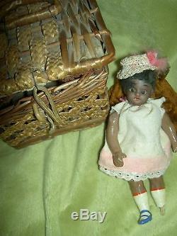 Antique dollhouse-size black bisque S & H sockethead mignonette doll withwardrobe