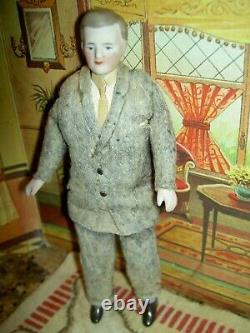 Handsome, 6 inch German, antique black bisque dollhouse doll dressed as servant